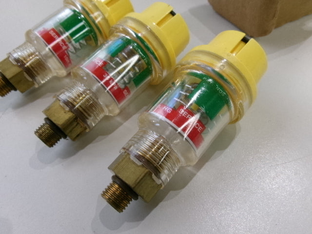 Three Racor vacuum indicators on a white surface